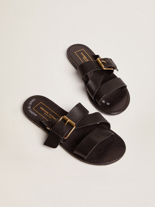 Margaret flat sandals in black resin-coated leather