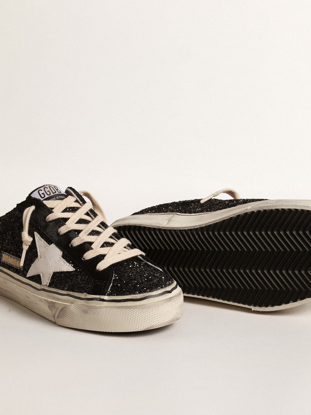 Super-Star Sabots in black glitter with white bio-based star