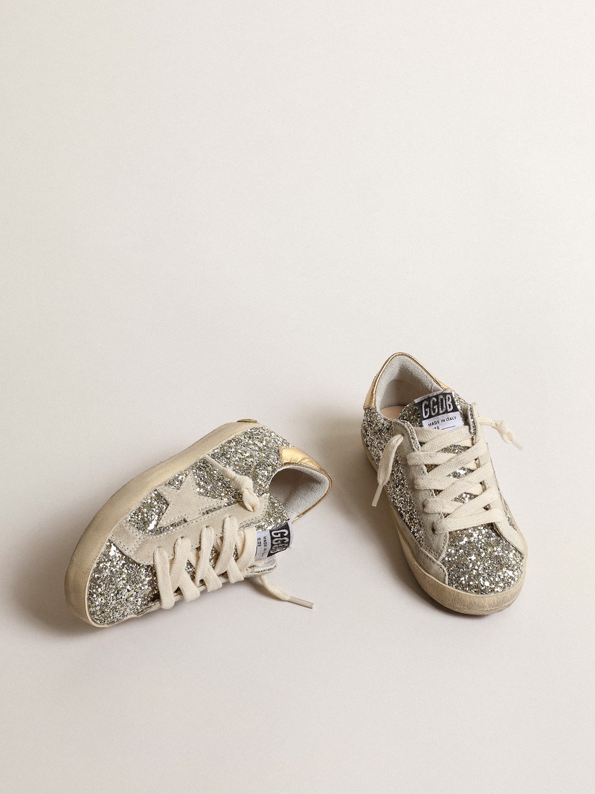 Super-Star Young in glitter with a suede star and gold heel tab