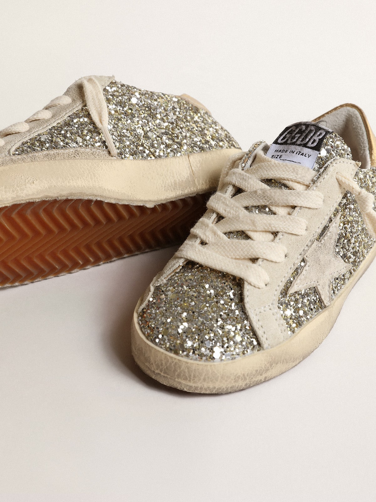 Super-Star Young in glitter with a suede star and gold heel tab