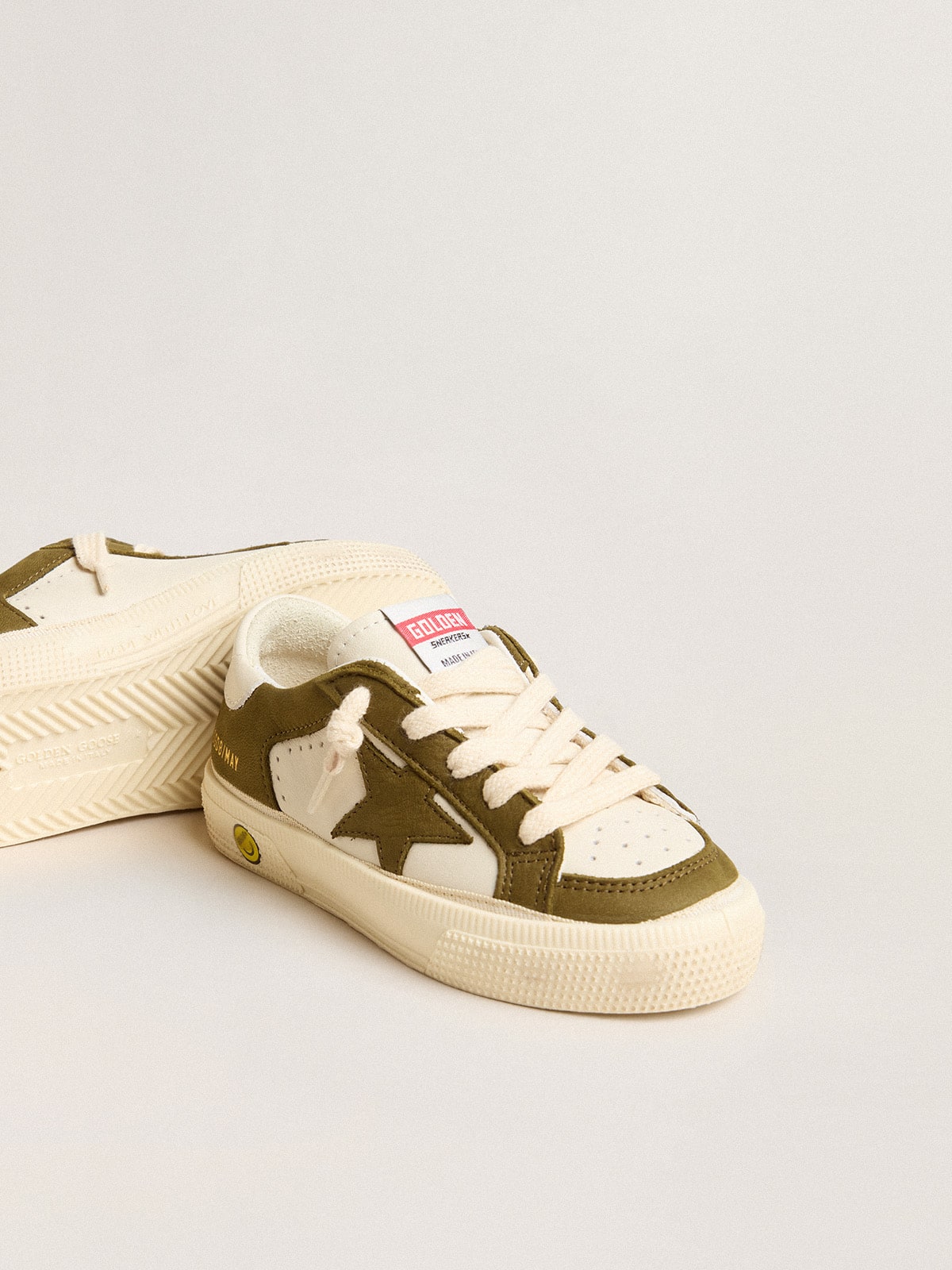 May Young in white and military green leather